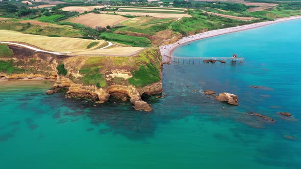 Aerial View of Beautiful Green Cliffs Red Rocks Mountain Sand Beach Waves Crushing on the Beach