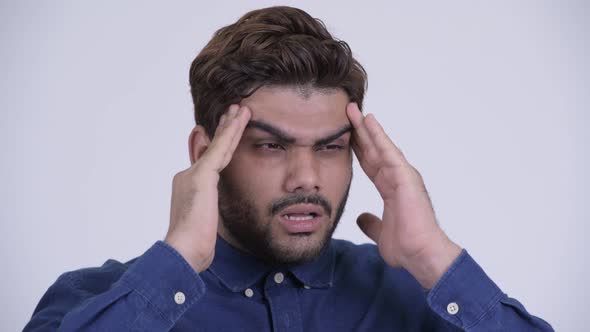 Stressed Young Bearded Indian Businessman Having Headache