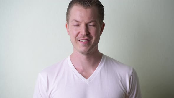 Face of Happy Young Handsome Man with Blond Hair Smiling