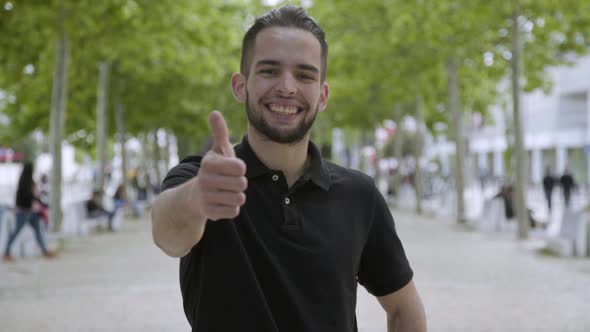 Smiling Young Bearded Man Showing Thumb Up