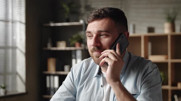 Smiling Sincere Young Man Communicating Distantly By Cell Phone Call Talking Speaking with Colleague