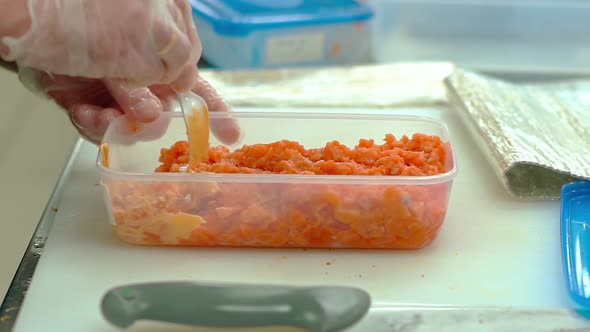 Cook Prepares the Filling for the Sauce, for Decorating the Japanese Rolls.