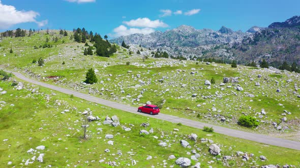 Aerial View of Road with Red Car in Beautiful Mountains in Komovi Montenegro