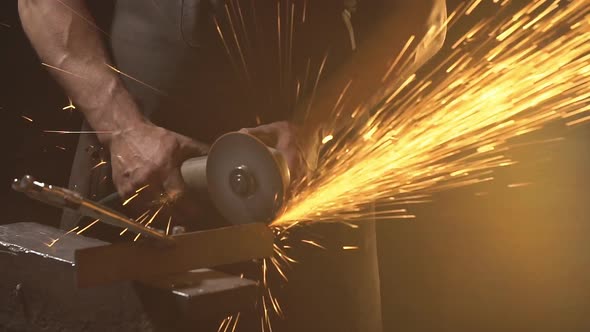 Sparks During Cutting of Metal Angle Grinder. Worker Using Industrial Grinder. Slow Motion