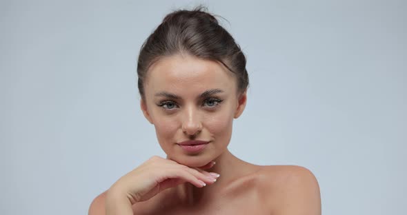 Beauty Portrait of Goodlooking Woman Who Softly Touches Her Chin with a Back of Her Hand Gently Lays