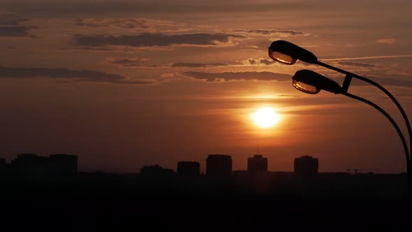 Sunset Over the City, a Lamppost in the Foreground