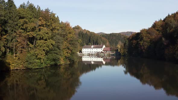 Aerial Above Lake with Autumn Foliage and Tree Reflections in Styria Thal Austria