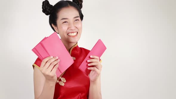 woman wear cheongsam and counting red envelope in concept of happy chinese new year