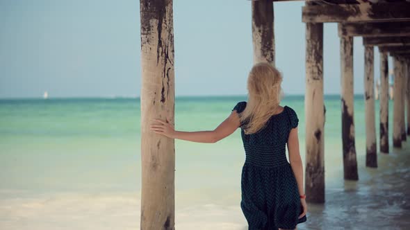 Girl In Summertime Season Sundress Leisure. Walking On Coastline And Hair Blowing On Wind.