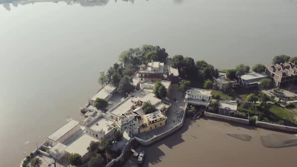 Aerial View Of Sadh Belo Island Temple On The Indus River, Pakistan. Follow Shot Back