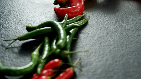 Various chili pepper on black background 4k