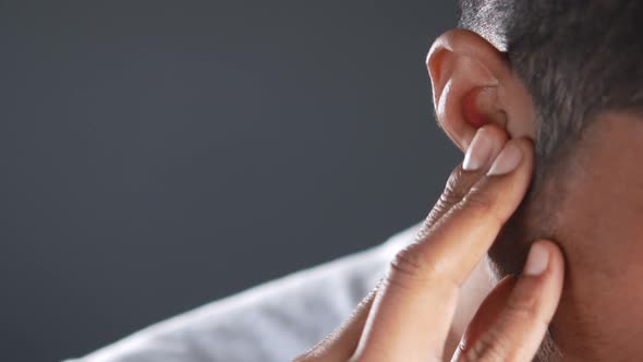 Young Man Having Ear Pain Touching His Painful Ear 