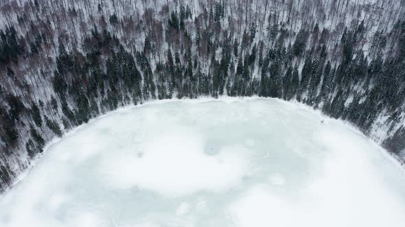 Frozen volcanic Saint Ann or Sfanta Ana lake crater, Romania. Aerial top-down forward