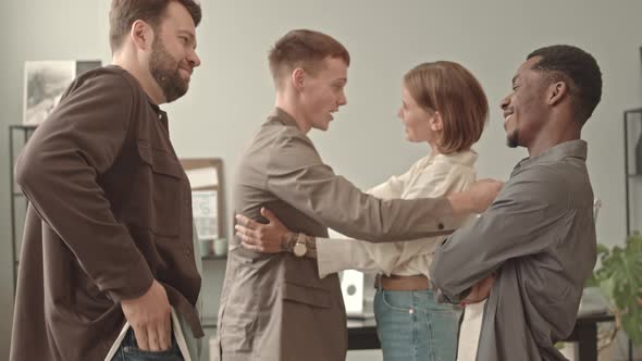 Four Colleagues Greeting in Office