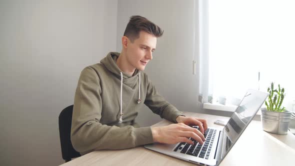 Modern Business Man Reading News on Laptop Computer in Office