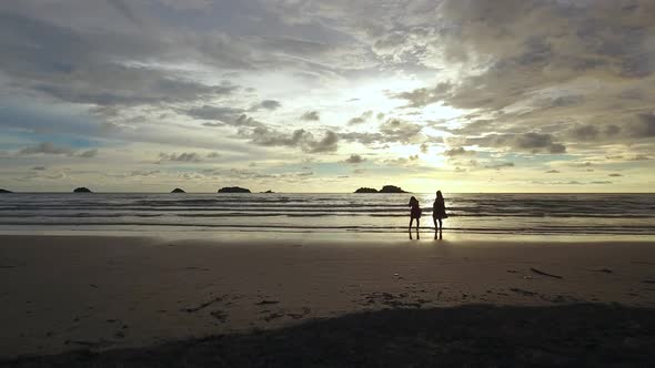 Aerial view of two womans taking photos of the sunset, Ko Chang, Thailand.