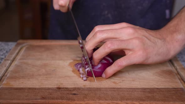 Chef showing how to cut onion into cubes