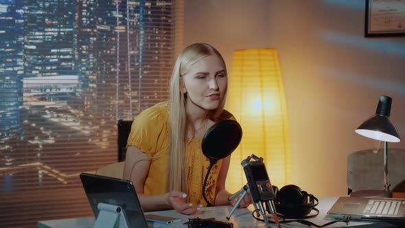 Cheerful Anchorwoman Telling About Something Into the Microphone in Home Studio