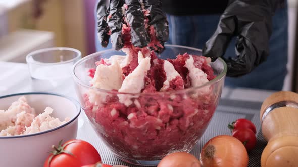 Kneading of Minced Meat with Onion and Spices in a Glass Bowl