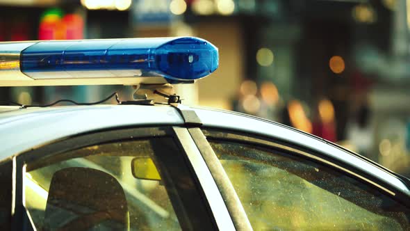 Flashing Flasher on the Roof of a Police Car. Blinker. Close-up.