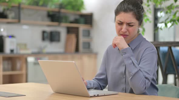 Indian Woman Coughing While Using Laptop at Work