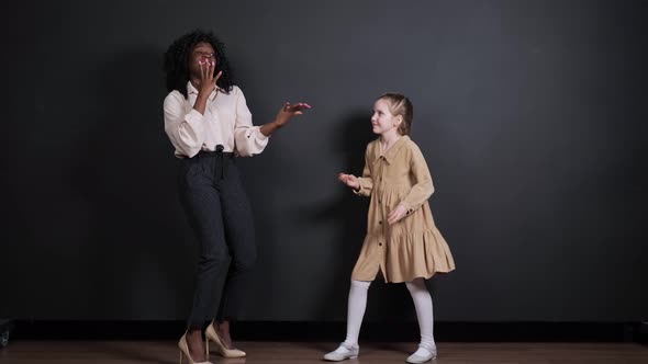 Afroamerican Stepmother and White Adopted Daughter Dance