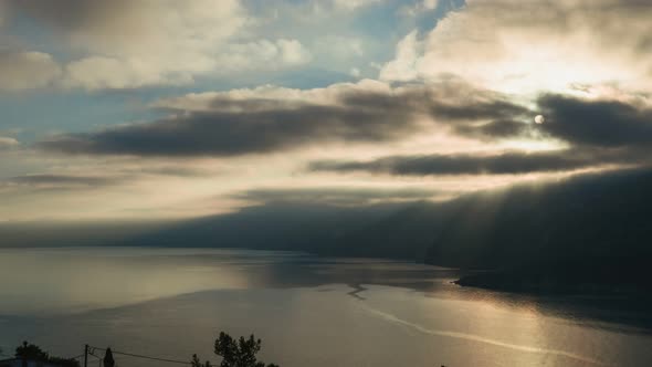 Dramatic and Moody Time Lapse Shot of Sunrise Over Rocky Shore and Calm Sea on Kefalonia Island