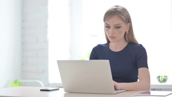 Woman Reacting to Loss While Using Laptop