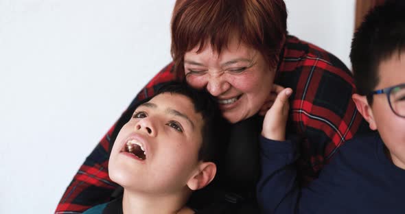 Happy mother having tender moment with her two sons at home