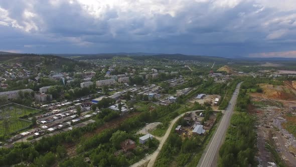 Aerial view of small Provincial industrial city with houses, garages and quarries 02