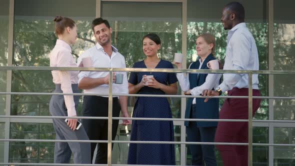 Multiethnic Business Team Chat and Drink Coffee Outside Office Building