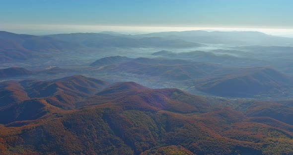 Aerial Panoramic Top View Over Mountain Autumn Forest Hills Covered with Gray Mist