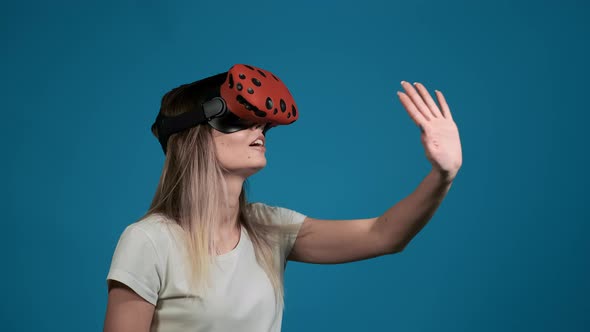 Positive Girl Touches Something Using Modern Vr Headset