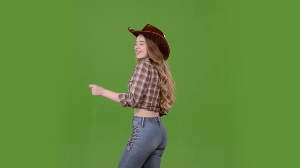 Cowgirl Dances, Standing with Her Back To the Audience. Green Screen. Slow Motion