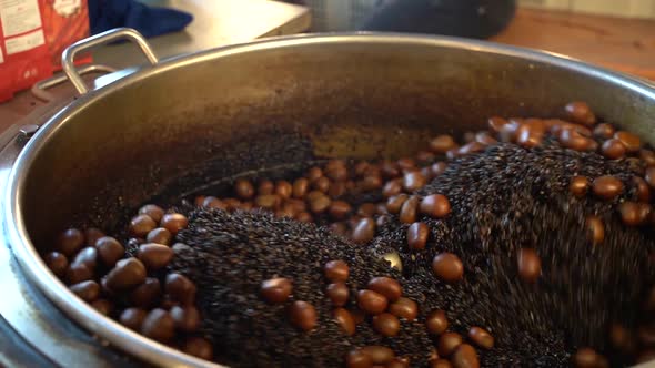 Chestnuts Being Roasted with Charcoals in the Industrial Stove in Local Street Market in Thailand