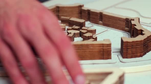 Close Up of Architect Hand Moving Over City Model