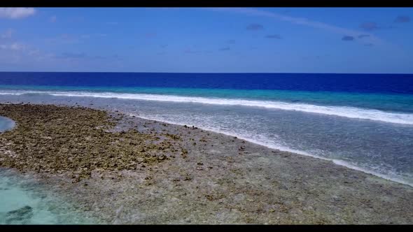 Aerial top down sky of marine seashore beach break by blue water with bright sand background of a pi