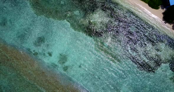 Tropical flying clean view of a sunshine white sandy paradise beach and blue water background in col