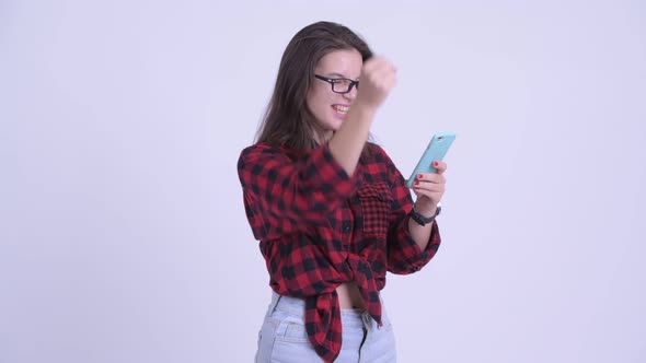 Happy Young Beautiful Hipster Woman Using Phone and Getting Good News