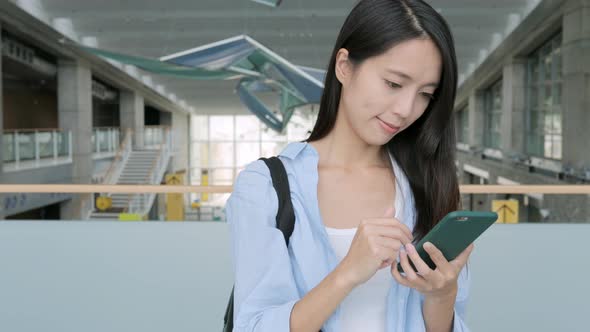 Woman Working on Mobile Phone in University