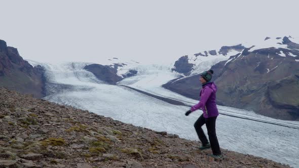 Women Rises on a Mountain Ridge