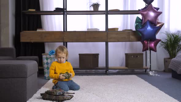 Little Cute Boy Learning To Use Remote Control Toy