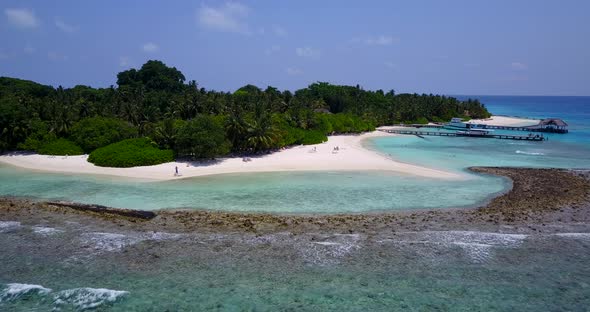 Tropical flying abstract view of a paradise sunny white sand beach and blue ocean background in 4K