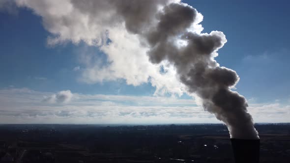 White Smoke From the Chimney on a Background of Blue Sky with the Sun