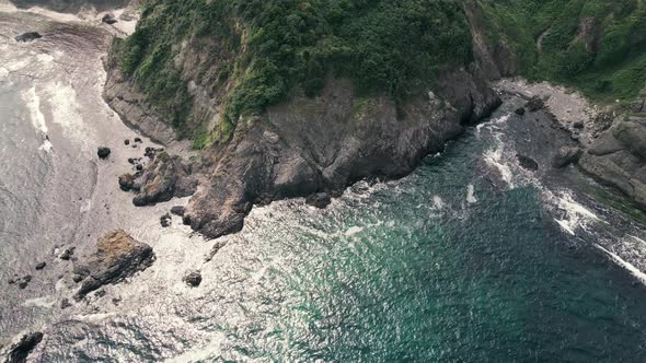 waves crashing cliffs view from drone shot