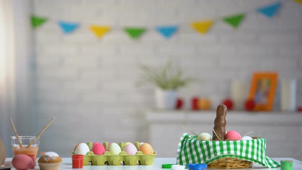 Cute Girl Jumping Like Rabbit From Under Table and Looking at Bright Easter Eggs