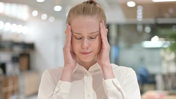 Portrait of Exhausted Young Businesswoman Having Headache