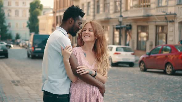 Young Couple in Love Standing and Tenderly Cuddling on Streets of European Cities