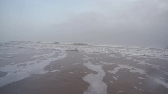 Beach Wave Incoming on Sand
