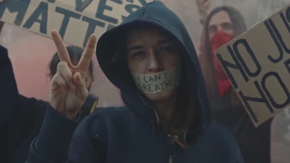 Person with Words I Cant Breathe on Face Shows Peace Gesture